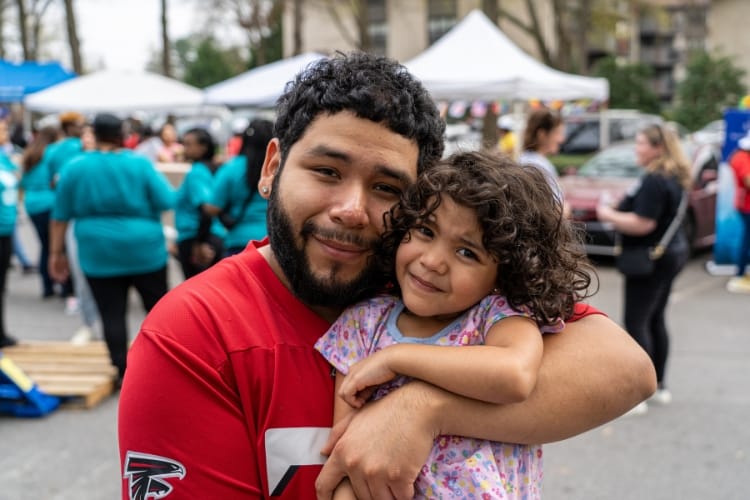 A man and a child at an outdoor event