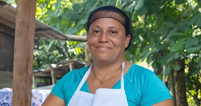Woman cooking food outdoors on a griddle