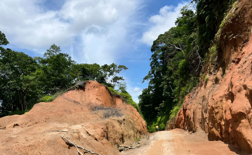 Large dirt and rocks along the sides of a gravel road