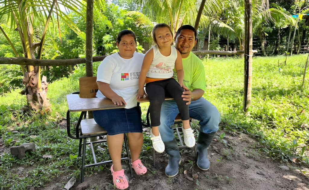 Yensy on a bench with other people outdoors