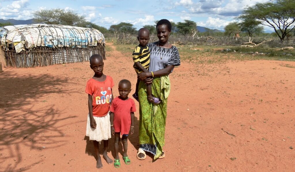Alesia and her three children outdoors in Kenya.