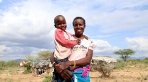 Alesia with her son outdoors in Kenya.